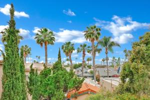 a group of palm trees against a blue sky at Spanish Style Cozy Studio in San Diego