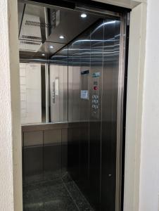 a elevator in a building with a mirror at Cantinho Verde in Santa Maria +9 photos