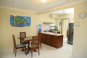 a kitchen with a table and chairs in a room at Apto CALETA BEACH 3HAB in La Romana