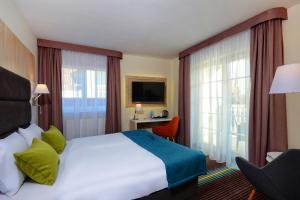 a hotel room with a bed and a large window at Stay inn Hotel Gdańsk in Gdańsk