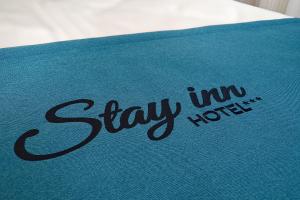 a blue towel with the words stay mi hotel on it at Stay inn Hotel Gdańsk in Gdańsk