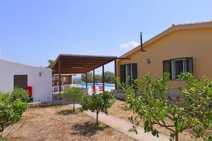 a house with a swimming pool in front of it at Holiday Home Floridia - ISI02274-F in Floridia