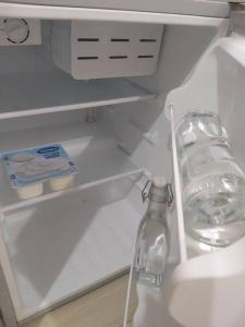 an open refrigerator with a bottle of water in it at The mini apartment includes breakfast in Hanoi