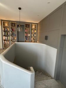 een groot wit bad in een kamer met boekenplanken bij Luxury villa in Vence with panoramic sea views in Vence