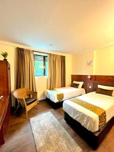 Postel nebo postele na pokoji v ubytování Melur Inn