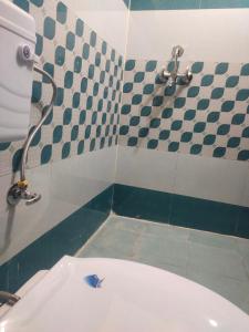 a bathroom with a toilet with a blue fish on it at Krishna Kunj Homestay Rishikesh in Rishīkesh