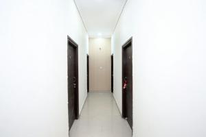 a corridor of a hallway with two doors in a building at Flagship 13088 Hotel Basant in Rāja Sānsi