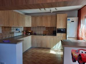 a kitchen with wooden cabinets and a red toy truck on the counter at Casa Mario in 2 Mai