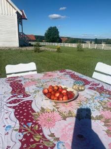 a table with a plate of fruit on it at Giżycko-Przerwanki Domki Widok na Mazury in Giżycko