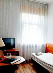 TV a/nebo společenská místnost v ubytování Hotel Bursztyn