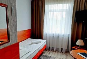 Postel nebo postele na pokoji v ubytování Hotel Bursztyn