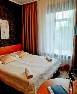 Postel nebo postele na pokoji v ubytování Hotel Bursztyn
