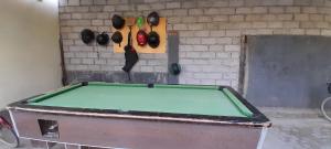 a pool table in front of a brick wall with a wall at Ekas beach guesthouse and restaurant in Ekas +10 photos
