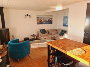 a kitchen and living room with a couch and a table at Amber's Place: cosy house with pool and sea views in Dubravica