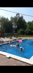 a group of people playing with a frisbee in a swimming pool at На ставку in Vyzhnytsya