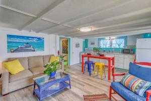 a living room with a couch and a table at Colorful Murrells Inlet Gem with Outdoor Space! in Myrtle Beach