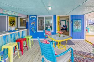 a colorful restaurant with a table and chairs at Colorful Murrells Inlet Gem with Outdoor Space! in Myrtle Beach