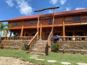 a log home with a staircase in front of it at Eco Floor Bird Song Lodge in Cat Tien