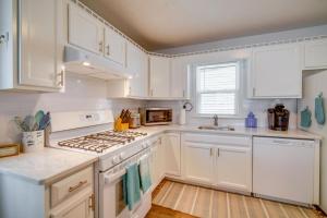 a kitchen with white cabinets and a stove top oven at Pet-Friendly Villas Vacation Rental Walk to Bay in Rio Grande
