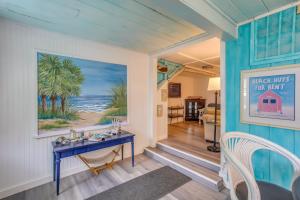 a dining room with a blue table and a painting on the wall at Murrells Inlet Apartment with Direct Beach Access! in Myrtle Beach