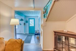a living room with blue walls and a staircase at Murrells Inlet Apartment with Direct Beach Access! in Myrtle Beach
