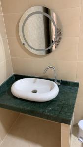 a bathroom counter with a sink and a mirror at Le ruban d’or in Azilal