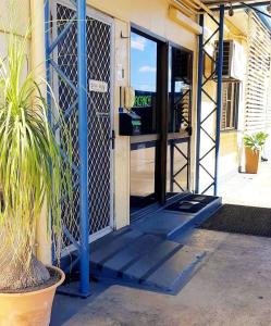 an entrance to a building with a door open at Burdekin Motor Inn in Home Hill