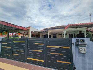 a black gate in front of a house at Taiping Aulong [3 rooms] nearby TF Mart/Econsave in Taiping