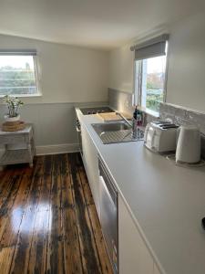 a kitchen with a sink and a counter top at Heritage Cottage in Sandy Bay in Sandy Bay