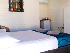 a bed in a room with two towels on it at Burdekin Motor Inn in Home Hill
