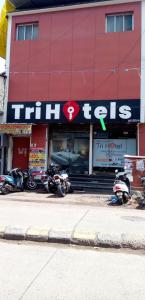 a red building with motorcycles parked in front of it at TRI HOTEL in Mumbai