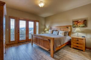 a bedroom with a large wooden bed and a window at Old Mill Lookout in Bend