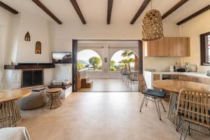 a living room with a table and chairs at Faidon's Luxury House with jacuzzi by AegianKazarte in Kapótidhes