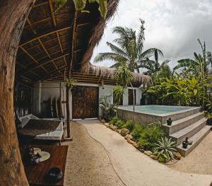 a resort with a swimming pool and a building at La Bohème Boutique Glamping in General Luna