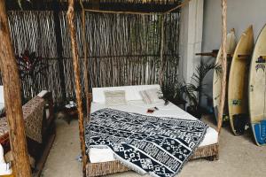 a bedroom with a bed in a room with surfboards at La Bohème Boutique Glamping in General Luna