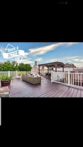 a large deck with a couch on top of a building at Fleet st Property in Baltimore