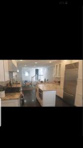 a large kitchen with white cabinets and a stove top oven at Fleet st Property in Baltimore