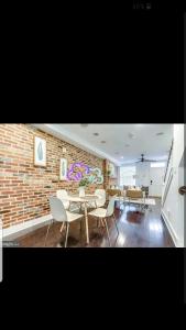 a dining room with chairs and a brick wall at Fleet st Property in Baltimore