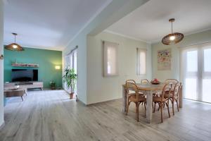 a dining room with a table and chairs at Villa Melias, luxurious villa with superb view of the islands, 400 m from the sea in Nydri