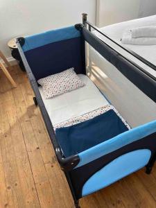 a blue bunk bed with a pillow on it at Schöne 2 Zimmerwohnung in Heusenstamm in Heusenstamm