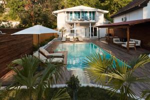 a swimming pool in the backyard of a house at River Breeze House in Sremska Kamenica