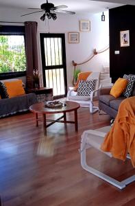 a living room with couches and a coffee table at Jonty Villa, Mazotos in Larnaka