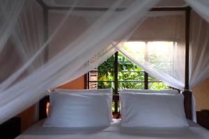 Voodi või voodid majutusasutuse Mwendawima Beach Villa toas