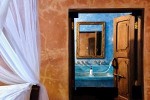 a bedroom door with a painting of a sink at Mwendawima Beach Villa in Jambiani