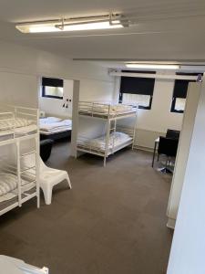 a room with several bunk beds in it at Family rooms in the center in Grindsted