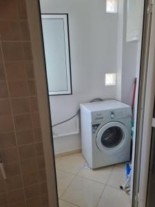 a laundry room with a washing machine and a window at Appartement Al hoceima in Al Hoceïma