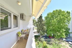 an apartment balcony with a view of a tree at Aspalathos dream apartment in Split