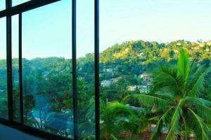 a view of a mountain from a room with windows at Luxury apartment The Walkers Nest in Kandy