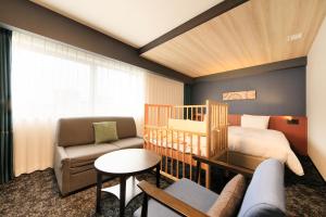 a baby room with a crib and a bed at Richmond Hotel Yokohama-Bashamichi in Yokohama