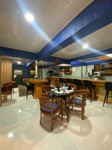 a dining room with a table and some chairs at Pondanu Cabins By The Lake in Bedugul